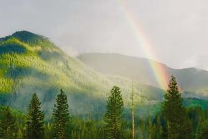Green mountainous landscape with a rainbow